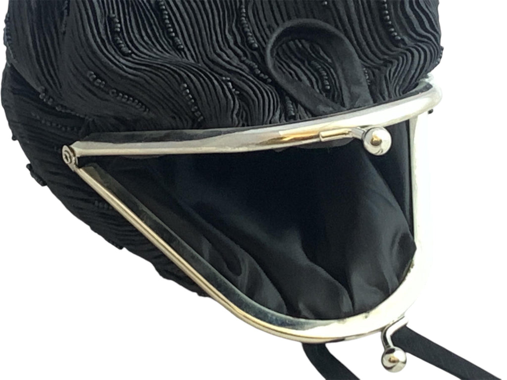 Small vintage evening clutch with intricate beading and wrist strap