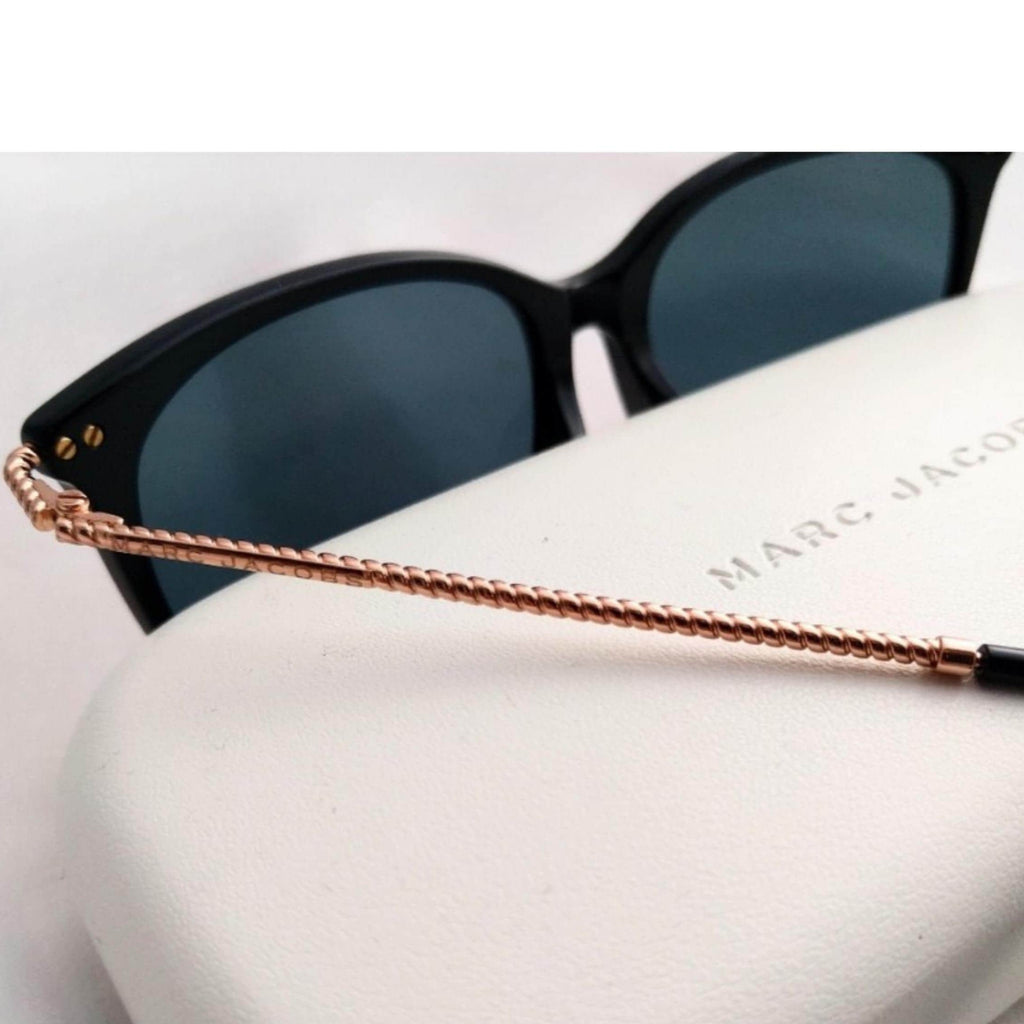 Luxury Marc Jacobs black plastic sunglasses with yellow lenses, fashion-forward design