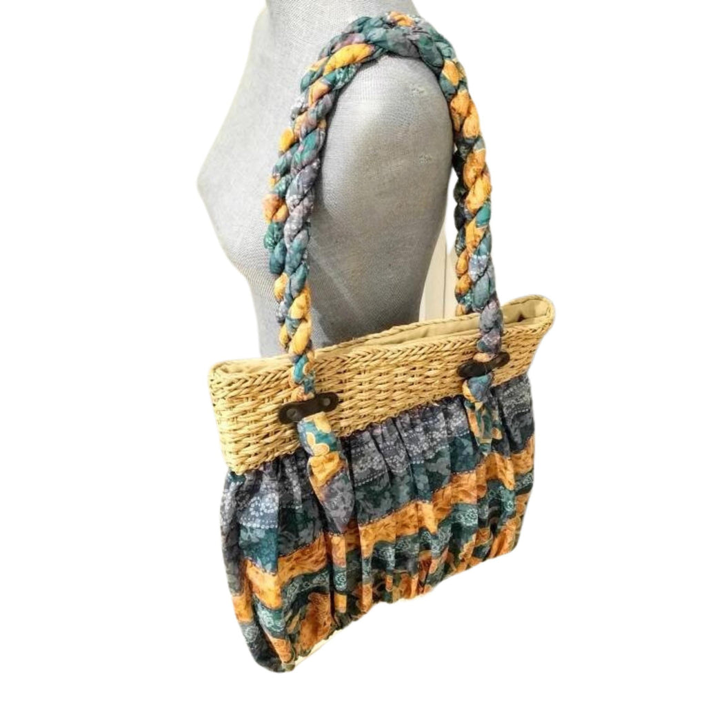 Handwoven straw tote with ruffled fabric trim, braided shoulder straps, summer handbag