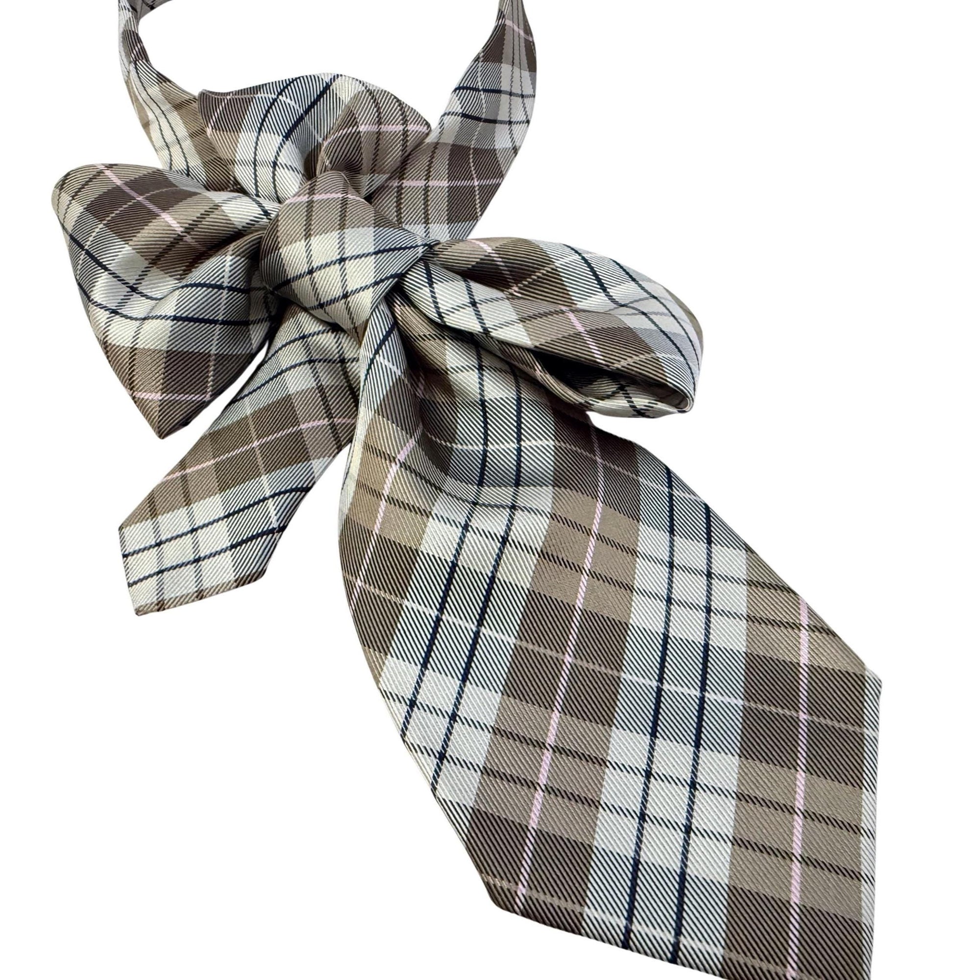 Flat lay of a handmade designer necktie featuring an intricate Italian silk weave in earthy tones, styled on a textured white background.