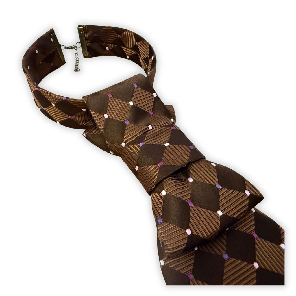 Close-up of hand-styled Enzo Feldini silk tie, showing the adjustable metal clasp and structured crossover fold.