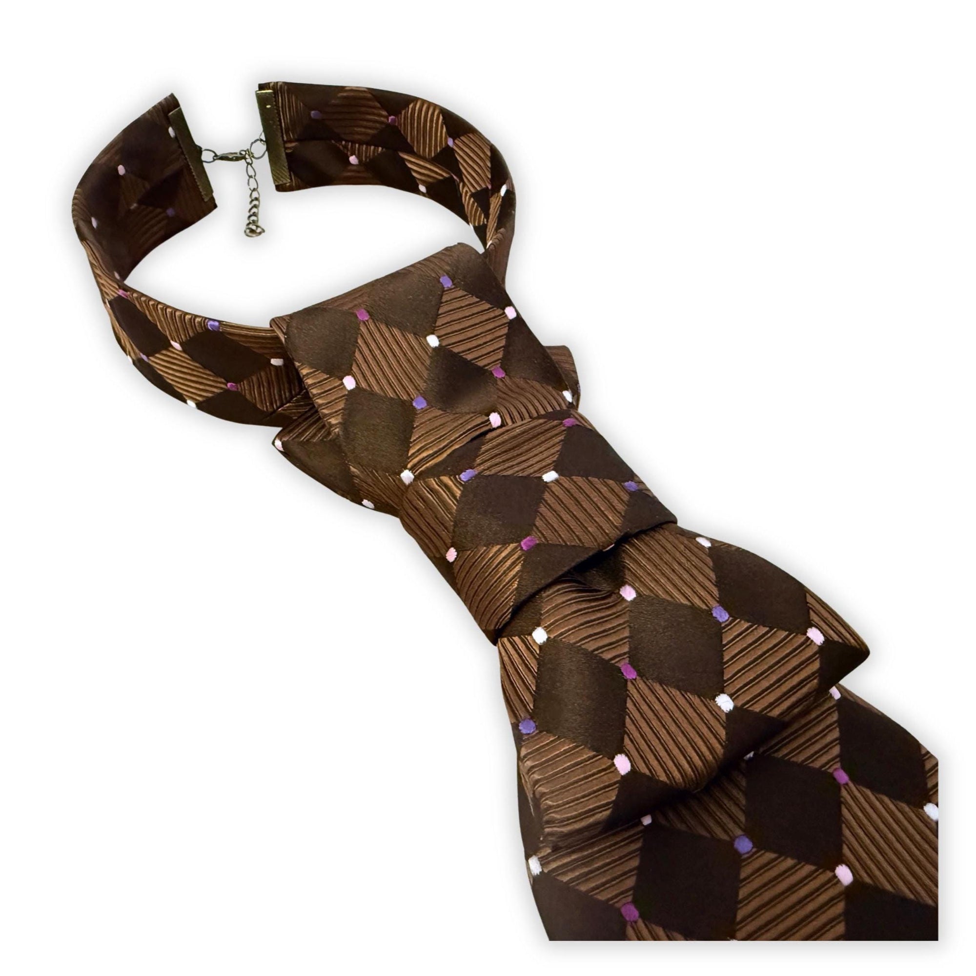 Close-up of hand-styled Enzo Feldini silk tie, showing the adjustable metal clasp and structured crossover fold.