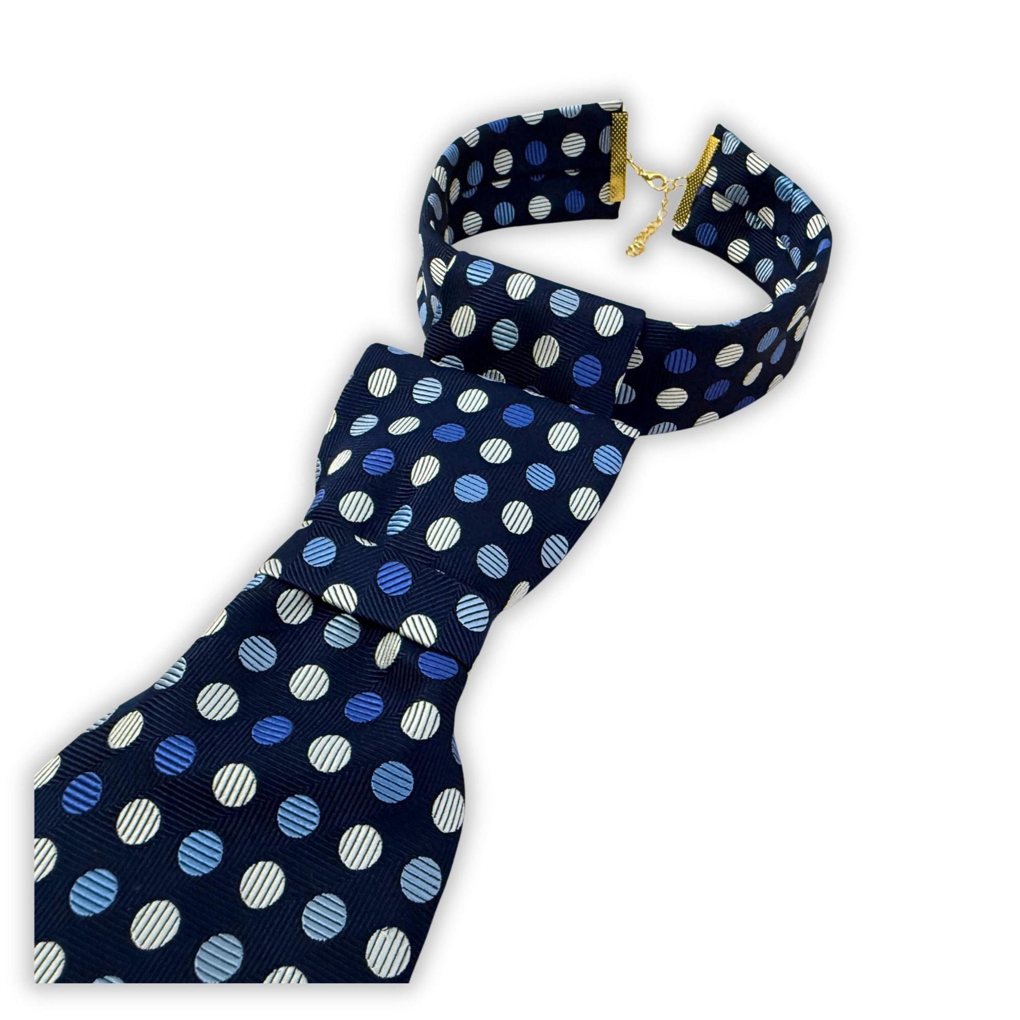 Flat lay of a handmade women’s butterfly-style necktie made from a vintage English designer tie featuring a vibrant blue and white dot pattern.
