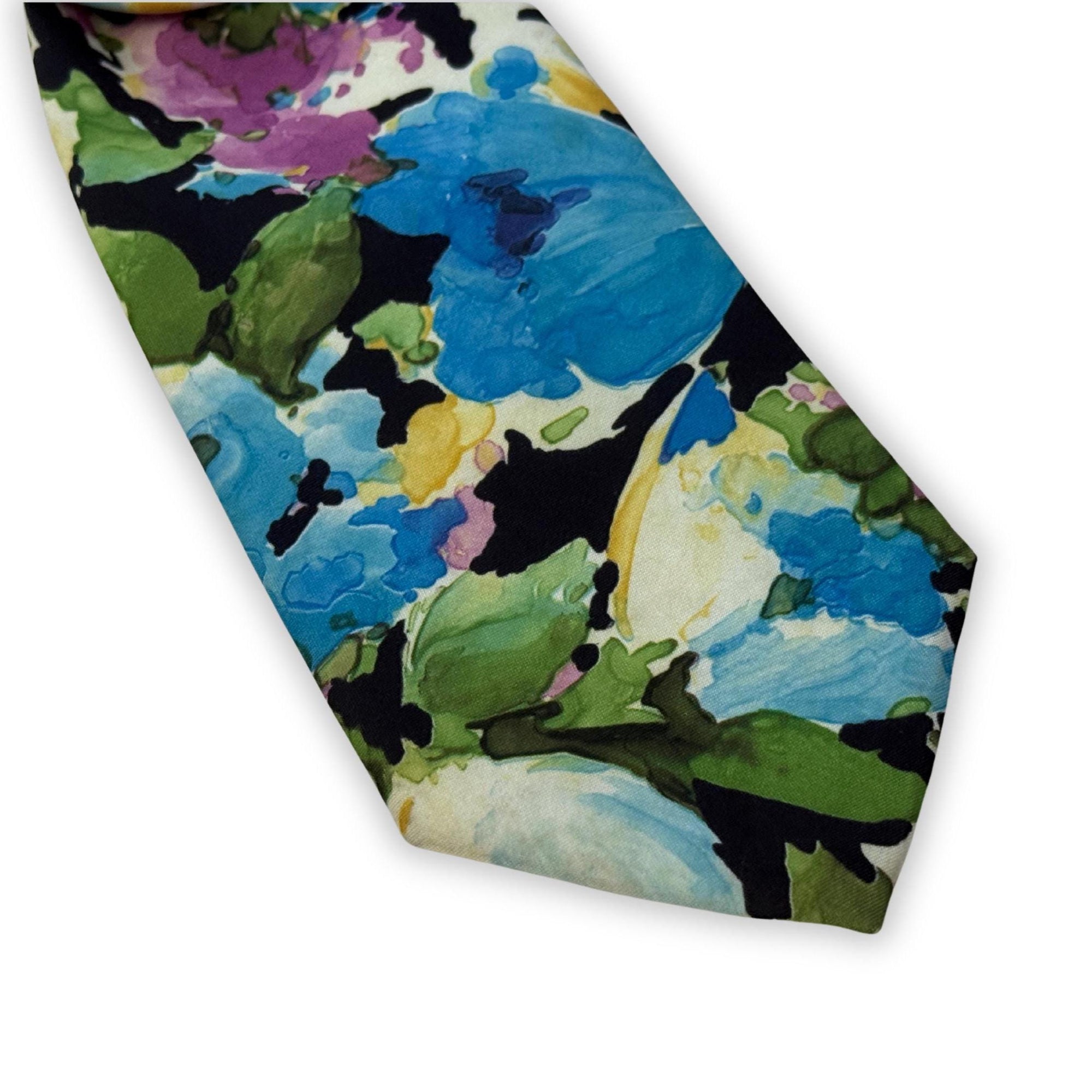 Detailed shot of the intricate floral print and tiered fold on a hand-styled blue vintage tie, showcasing the artistic azure tones.