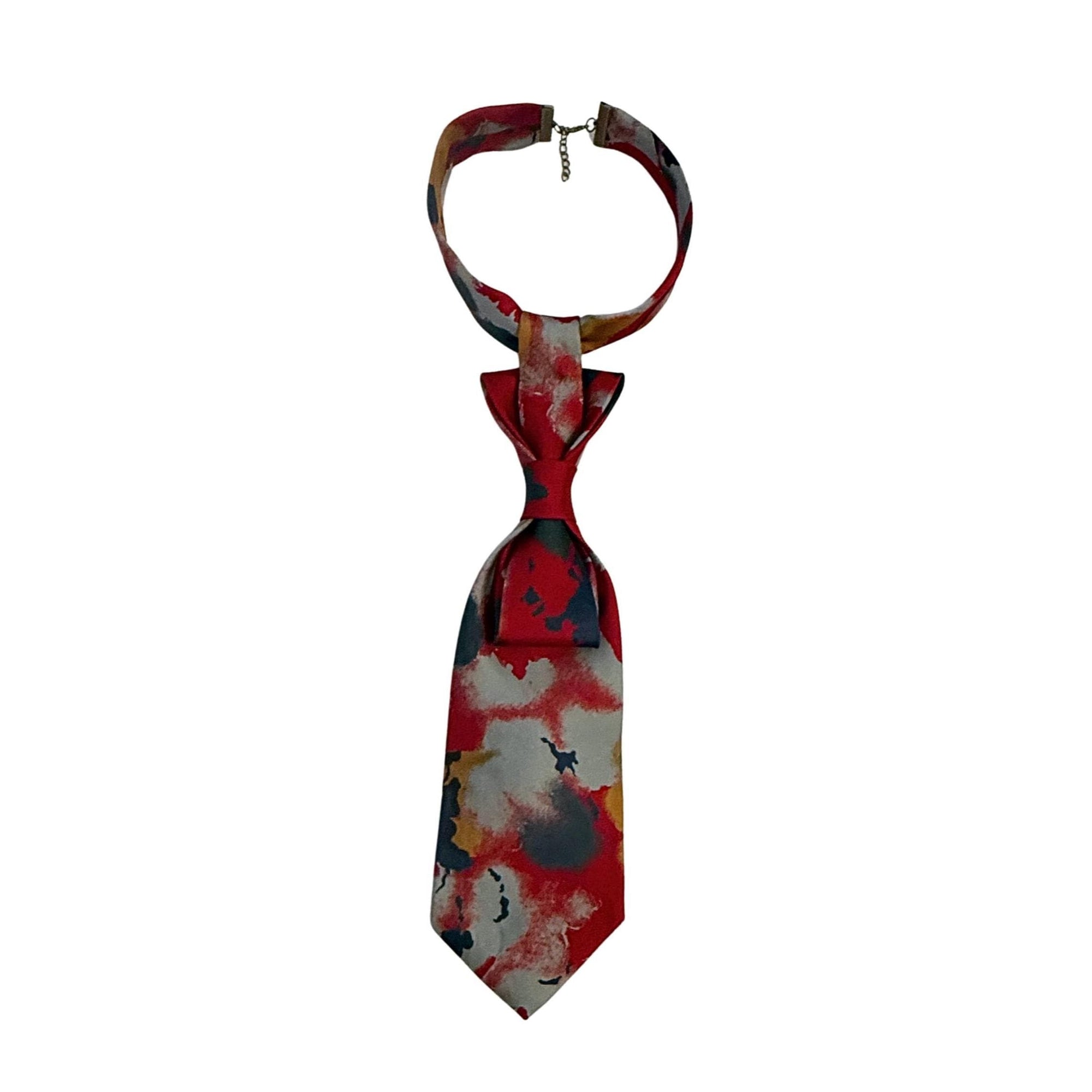 A repurposed crimson and graphite abstract silk tie reworked into a women's continental crossover style with an adjustable bronze-tone chain.