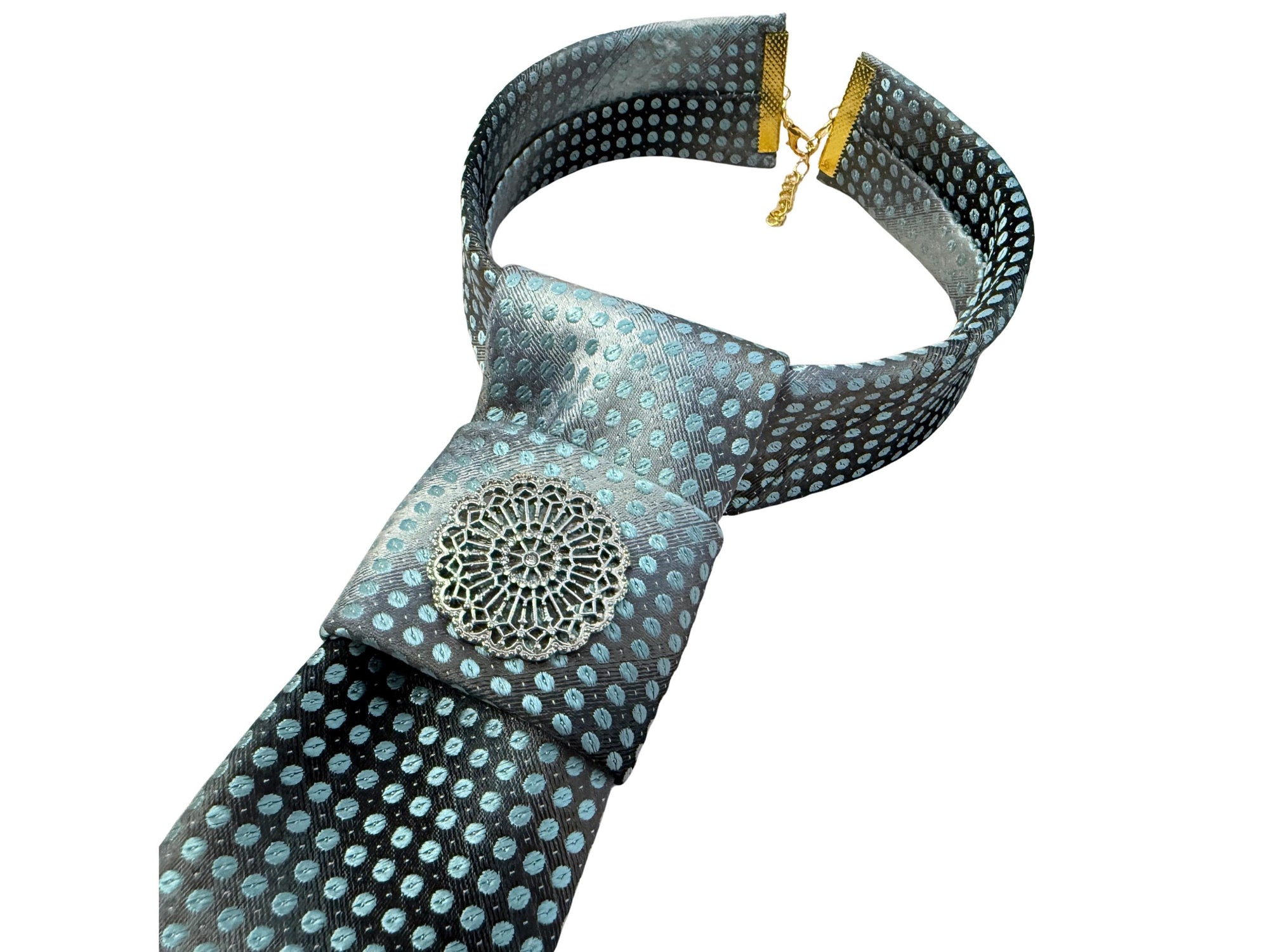 Flat lay of a handmade women’s butterfly-style necktie with a dramatic black and grey gradient and an adjustable gold-tone chain clasp.