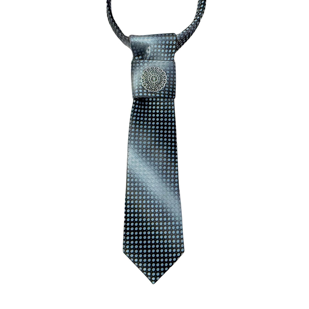 A repurposed charcoal to silver ombré vintage tie reworked into a women's continental crossover style featuring a silver filigree medallion.