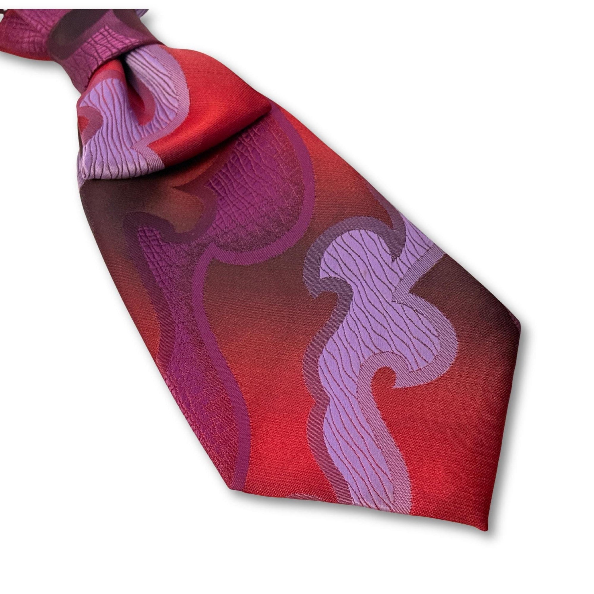 Flat lay of a handmade women’s butterfly-style necktie made from a vintage Lancer tie featuring a bold purple and red swirl pattern.