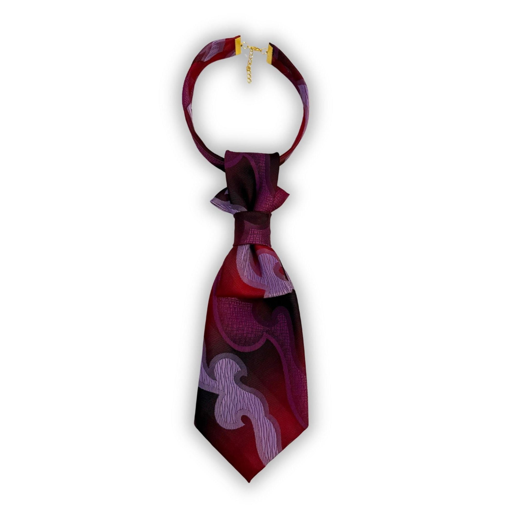 A hand-styled women's necktie in deep purple tones, displayed on a clean white background to showcase the tiered geometric fold and artistic print.