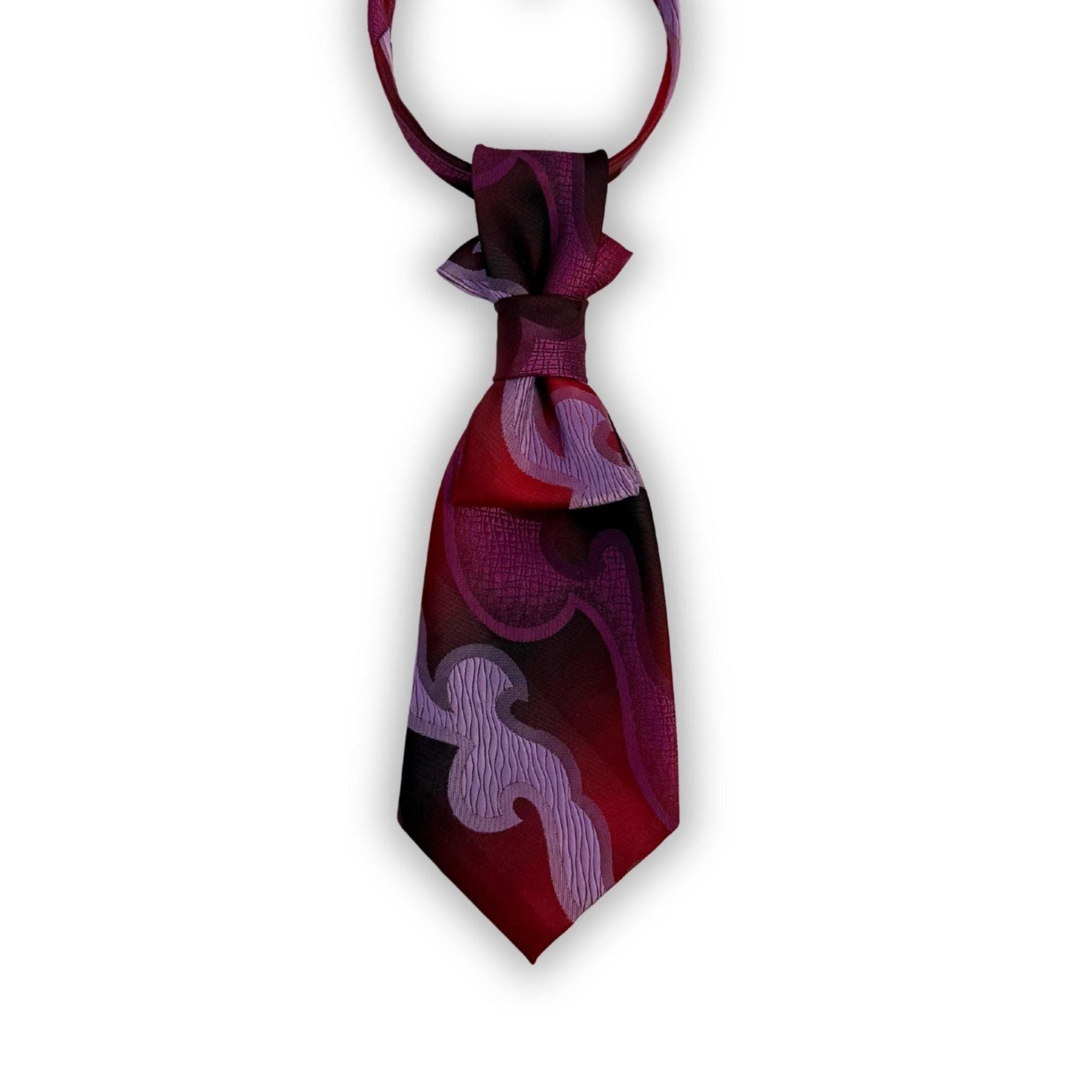 A repurposed magenta and violet abstract Lancer tie reworked into a women's continental crossover style with a gold-tone adjustable chain.