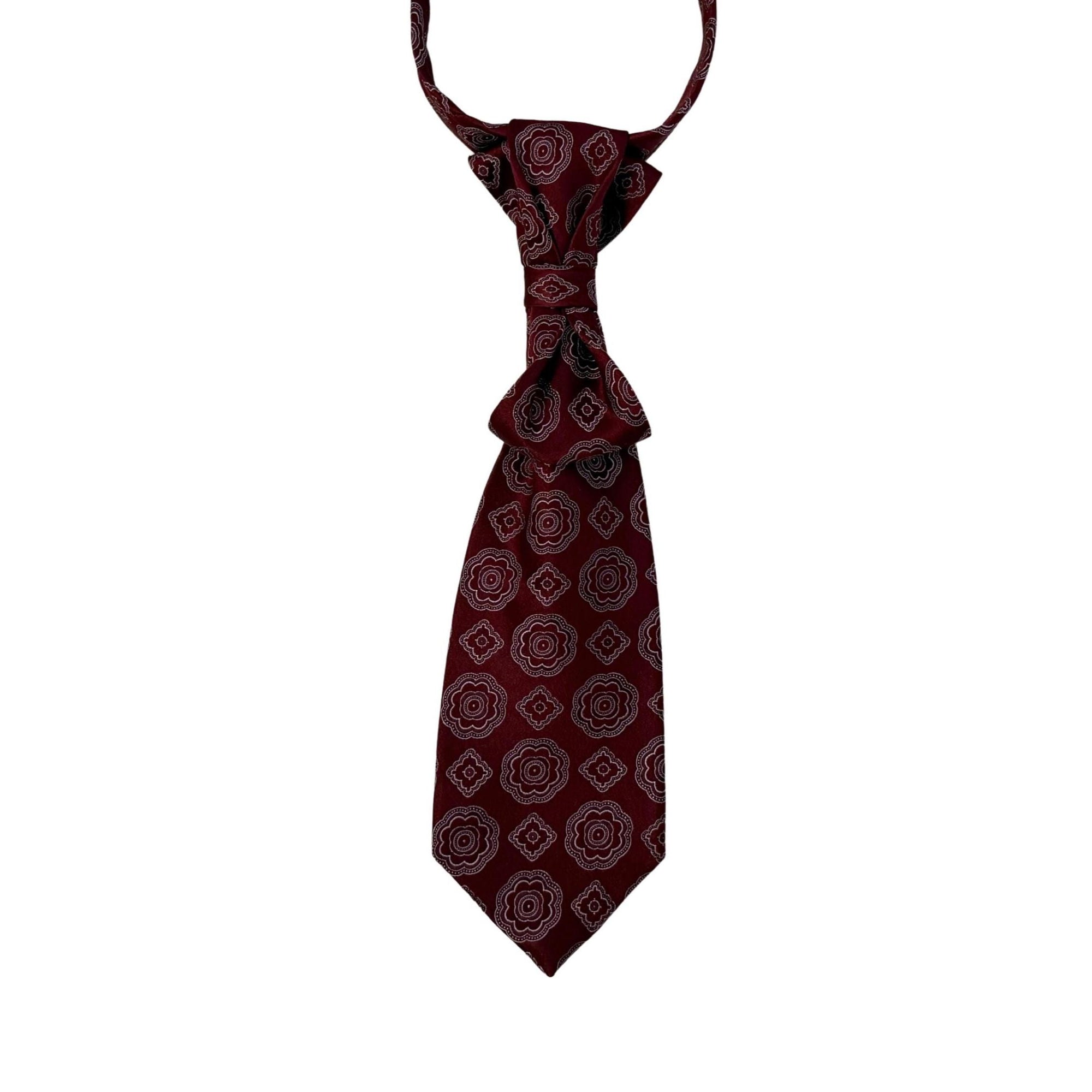 A hand-styled women's necktie in a deep wine-red bordeaux, displayed on a crisp white background to highlight the elegant crossover fold and adjustable gold-tone chain.