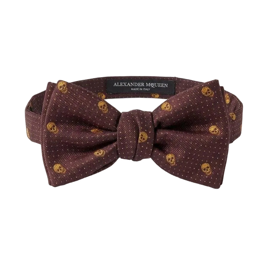This Alexander McQueen bow tie is a quintessential piece of dark romanticism, featuring the brand's most iconic motif in a sophisticated, formal colorway. The juxtaposition of the playful polka-dot backdrop with the edgy skull print makes it a versatile statement piece for those who appreciate rebellious luxury.