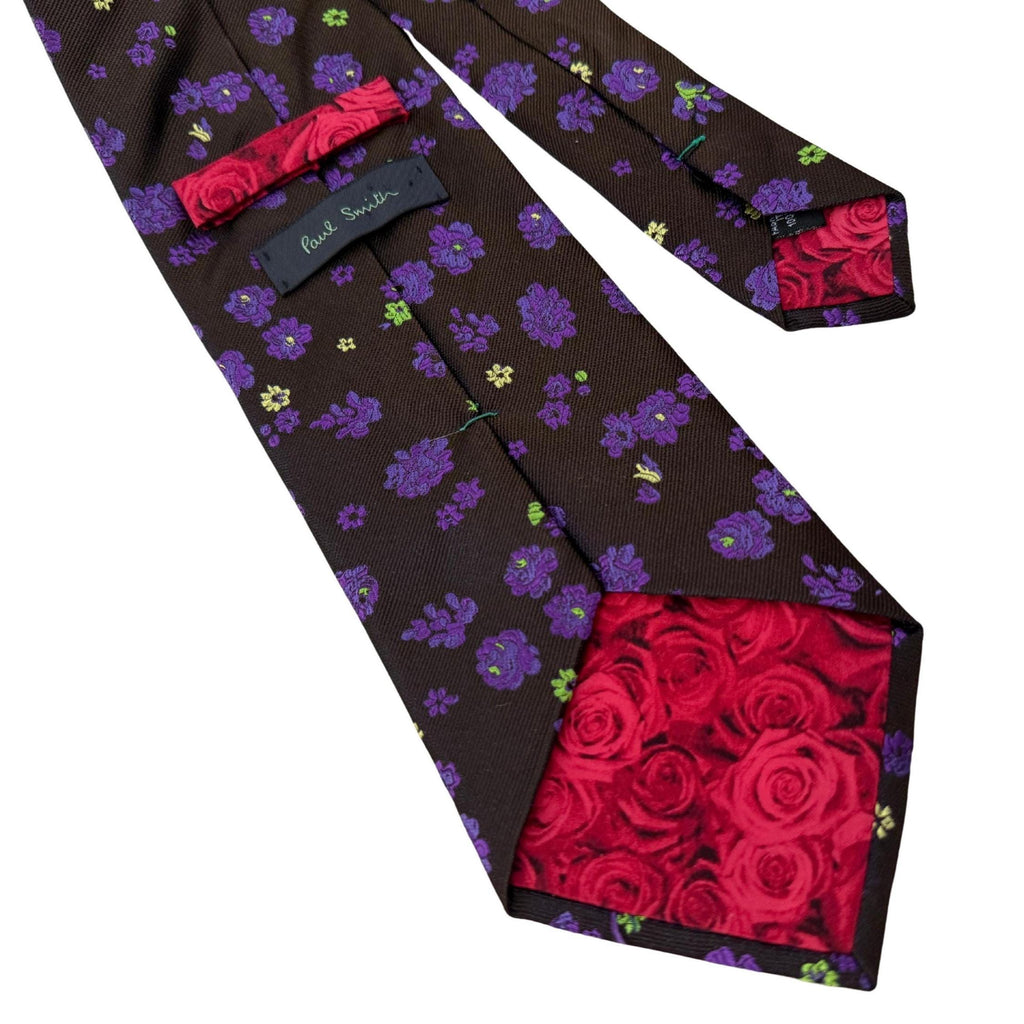 Authentic Paul Smith Italy silk tie. Features a bold 10cm blade, violet botanical print, and hidden red rose lining. Premium Mulberry silk for the design-conscious professional.
