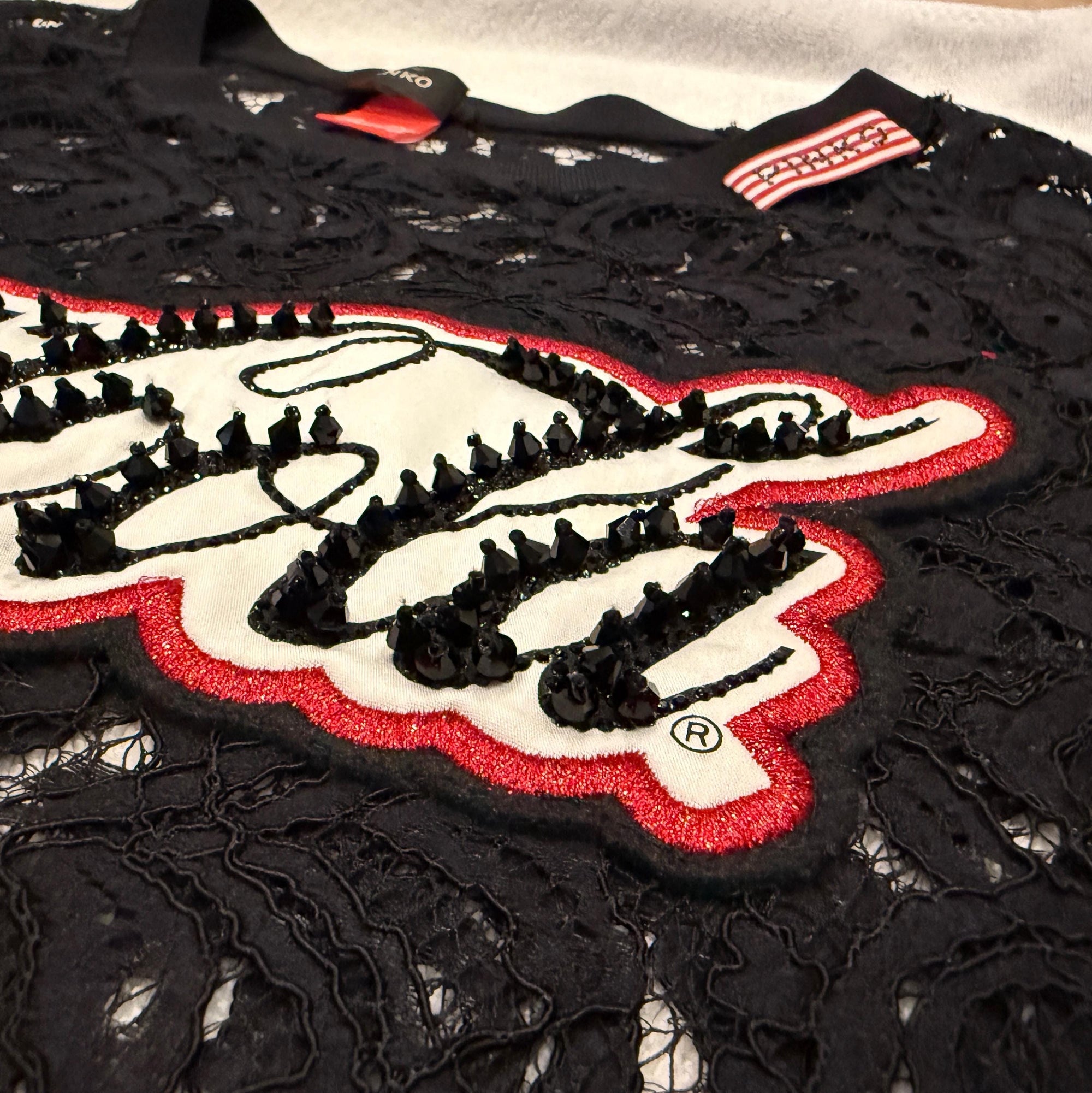 Coca Cola for Pinko Collaboration, black lace top, long-sleeved, semi-sheer, size medium, quirky unusual, iconic logo embellishment, very good preloved condition, pop culture fashion, casual chic, evening glamour, layered sophistication, fashion collaboration, statement piece.